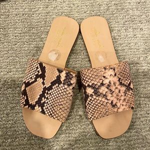 Pink and black animal print slides.